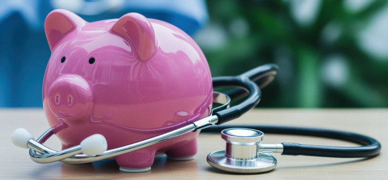Piggy bank with a stethoscope around it
