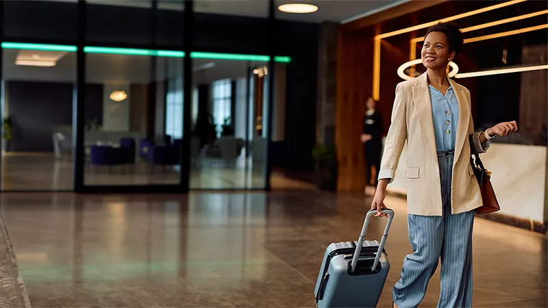 A woman pulling a luggage at a hotel lobby